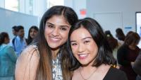 Two IHN alumni pose for a photo at a party